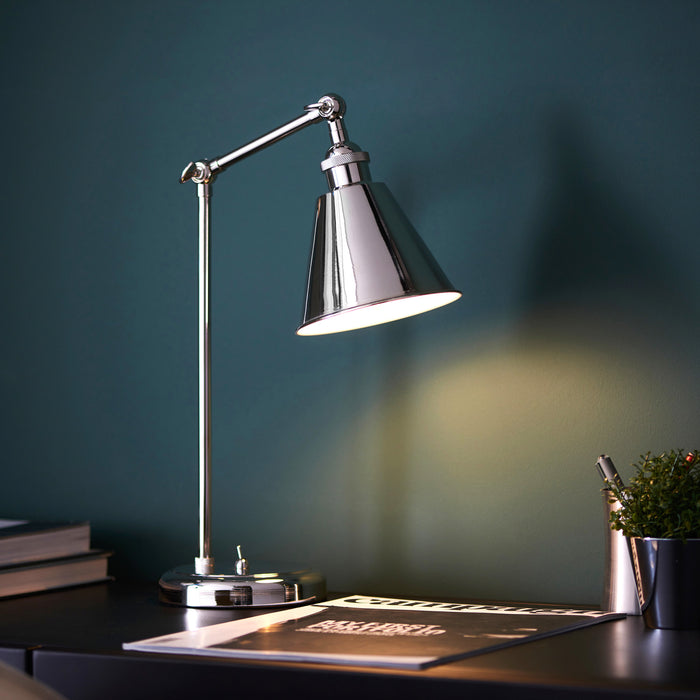 image of nickel table lamp shining light onto modern desk