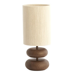 image cut out on white background of brown lamp with rounded base and cylindrical natural shade