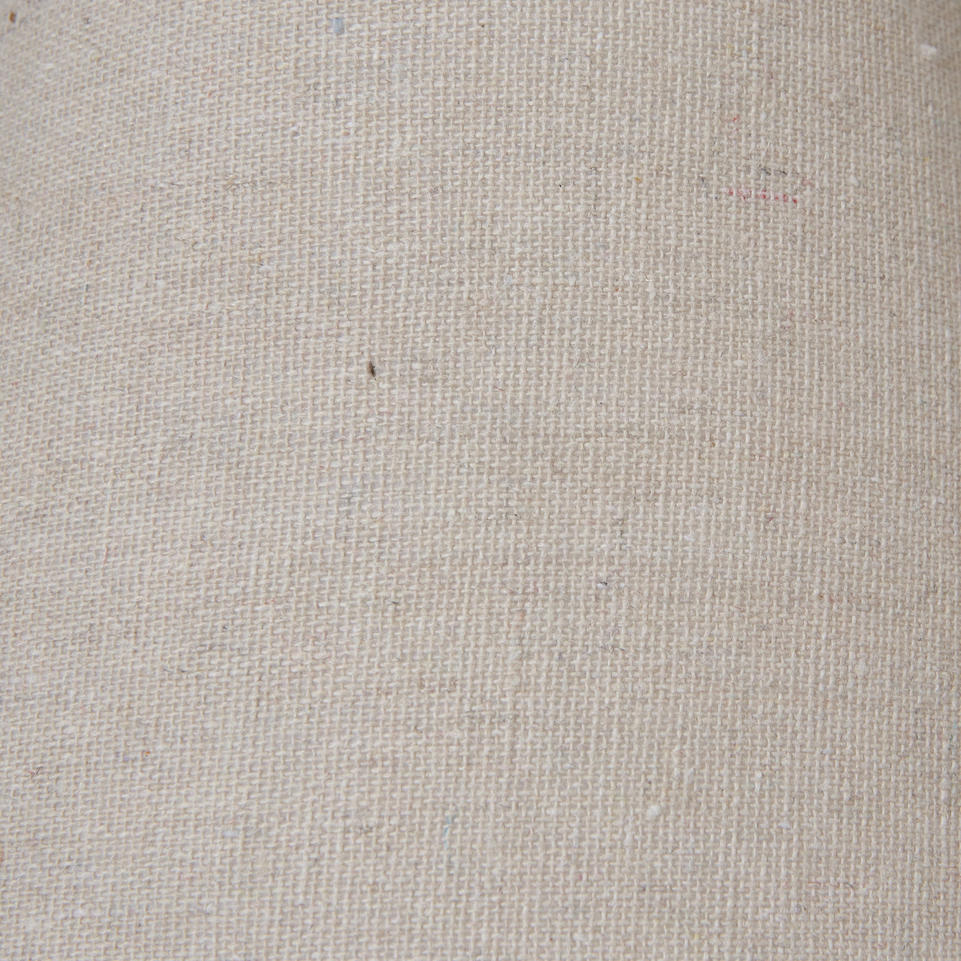 close up image of natural coloured linen shade on top of weathered-grey lamp