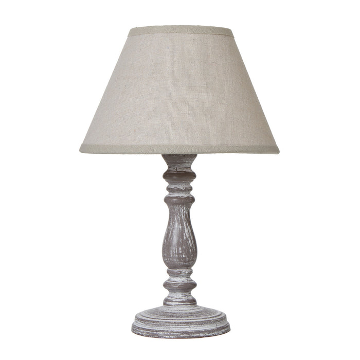 image cut out on white background of weathered-grey lamp base with natural linen edged shade