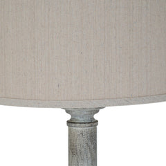 close up image of natural linen shade with grain, on top of white resin lamp