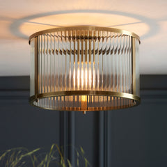 image of ribbed ceiling light in antique brass, close to cream ceiling