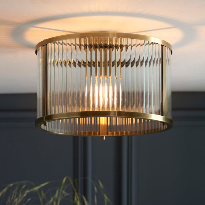 image of ribbed ceiling light in antique brass, close to cream ceiling