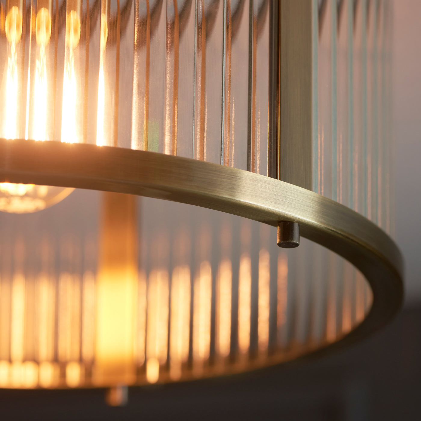 close up image of antique brass edges of ribbed pendant light