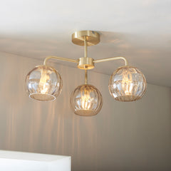 image of dimpled glass triple ceiling light with satin gold fixtures