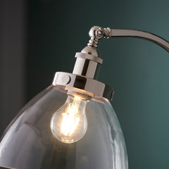 close up on clear glass lamp shade of nickel floor lamp with adjustable knuckle