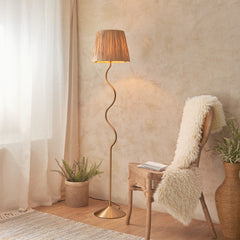 image of floor lamp with wiggle shaped brass body and textured shade