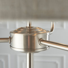 close up image of chrome-effect metalwork underneath shade of three armed lamp