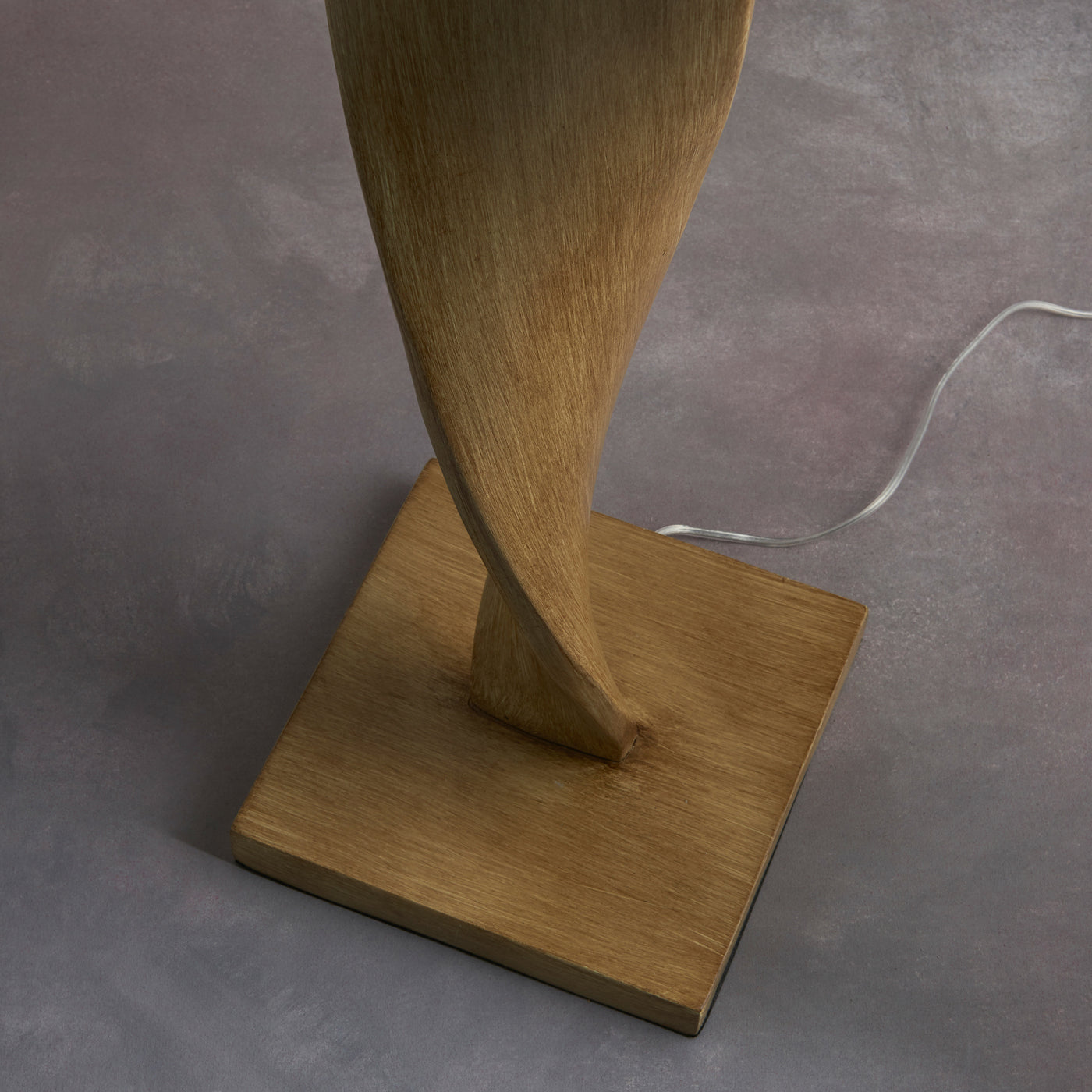 close up on slim bottom of lamp with small square base and inconspicuous cable