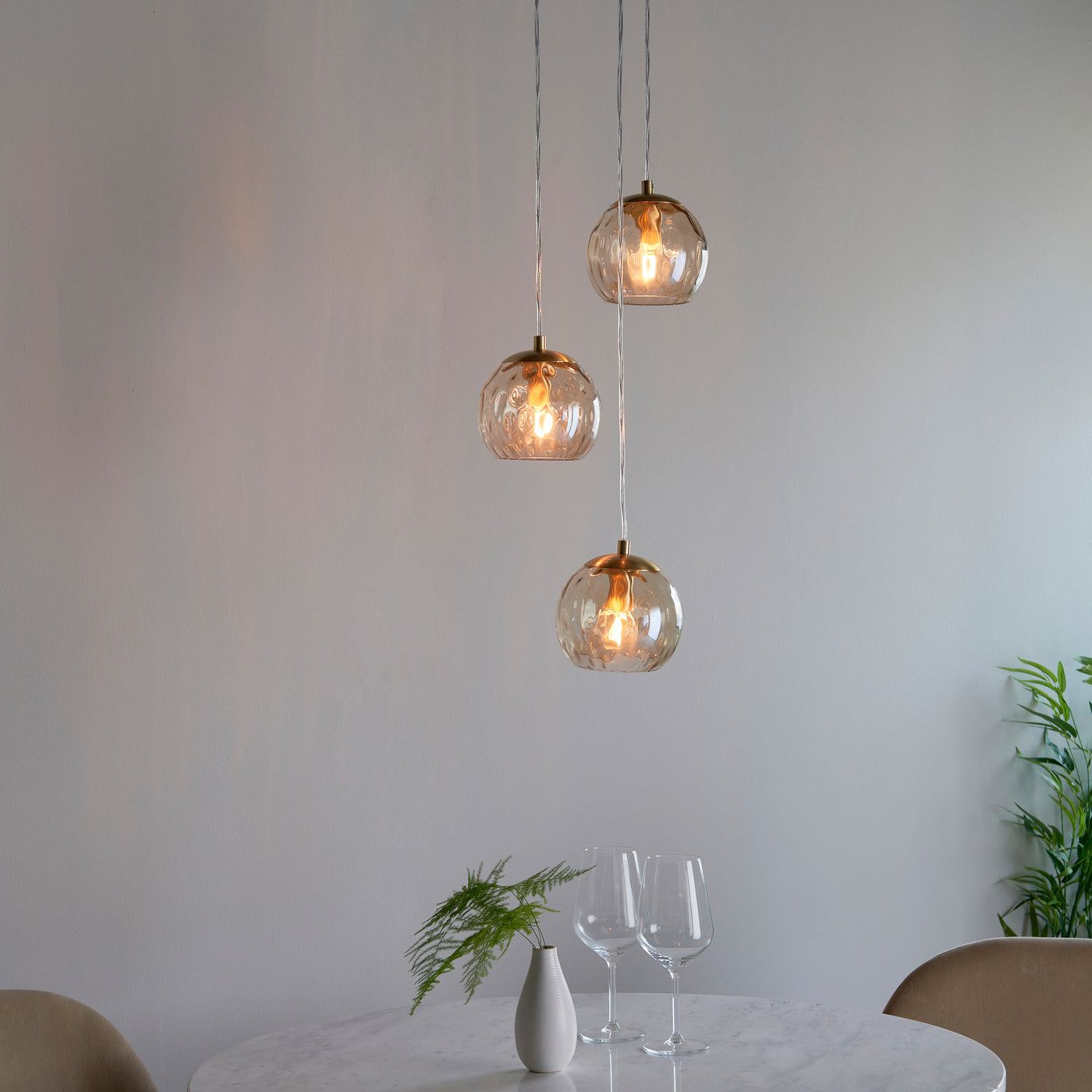 image of three dimpled glass lightshades on pendant cables