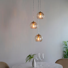 image of three dimpled glass lightshades on pendant cables