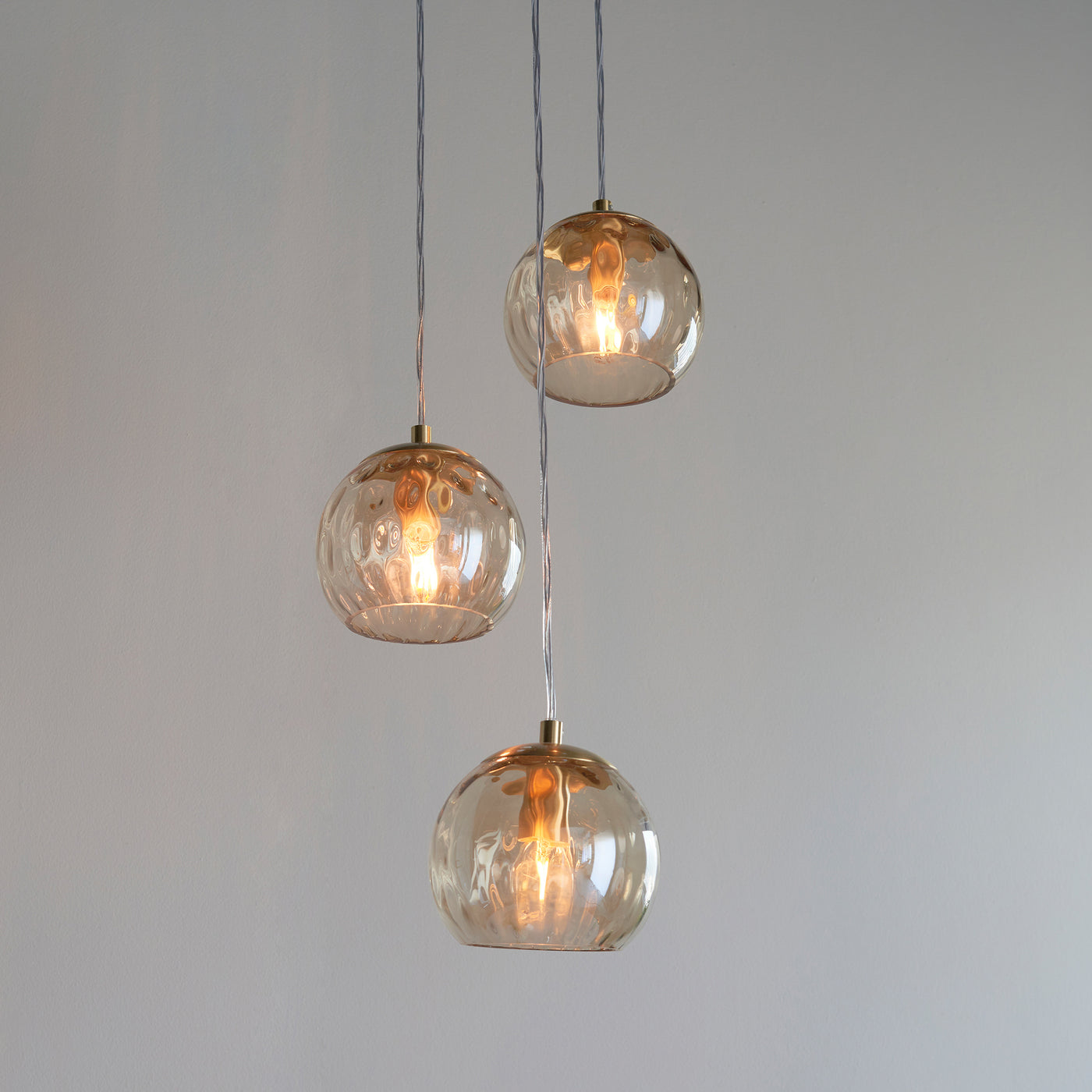 close up image on three dimpled shades of pendant light 