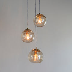 close up image on three dimpled shades of pendant light 