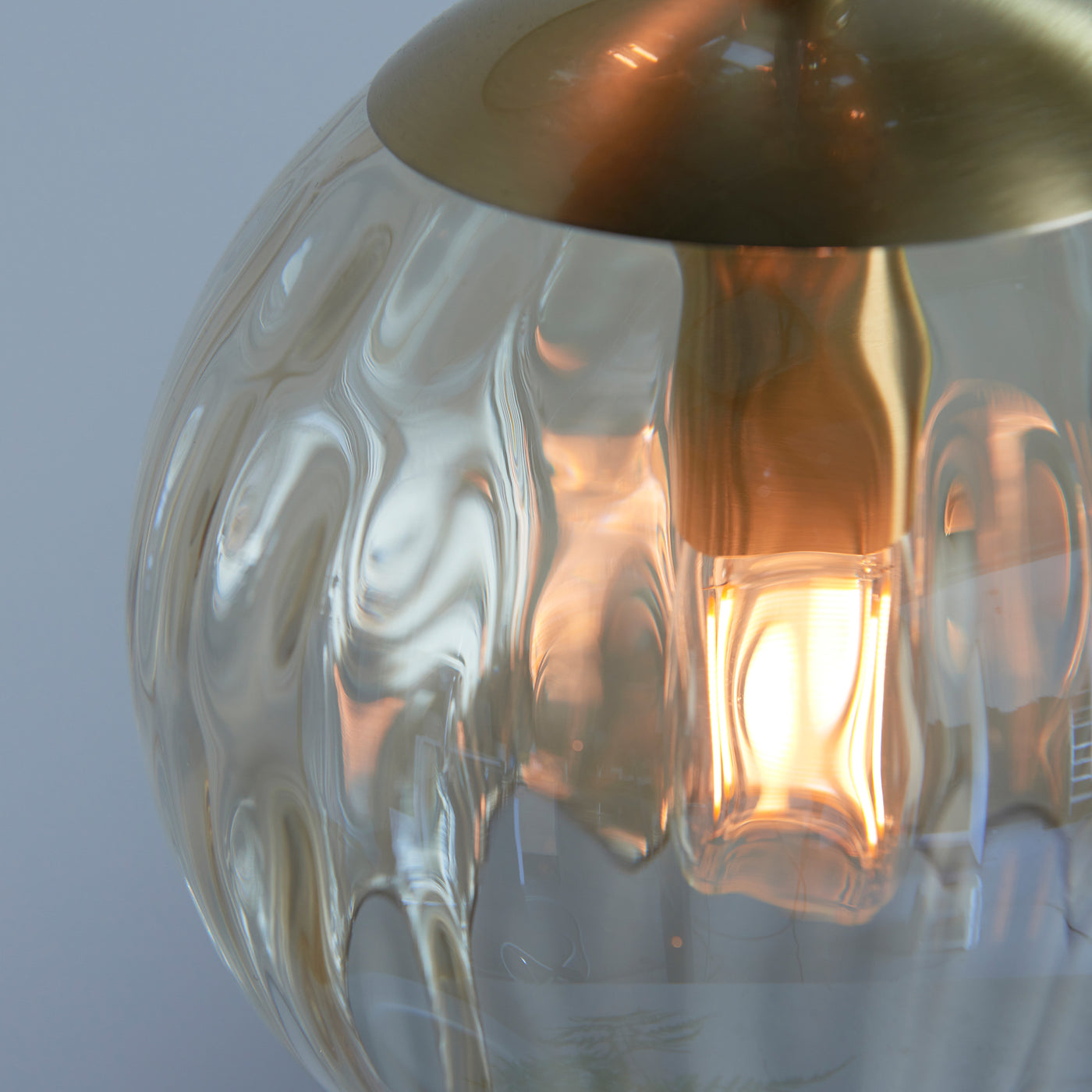 close up on dimpled glass of champagne coloured light