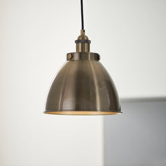 close up image of antique brass pendant light hanging from black cable