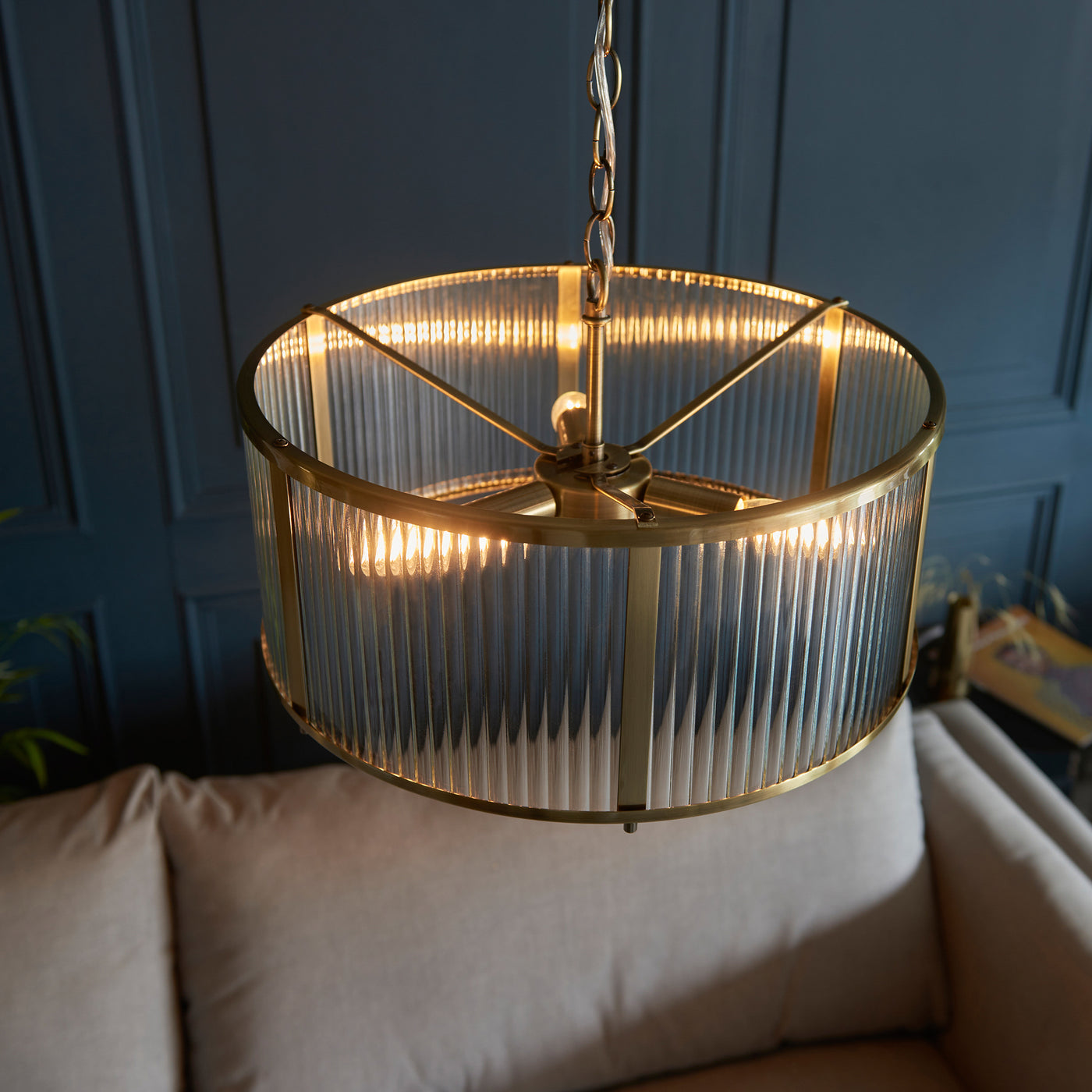 image taken from above of round pendant light with ribbed glass and antique brass metalwork