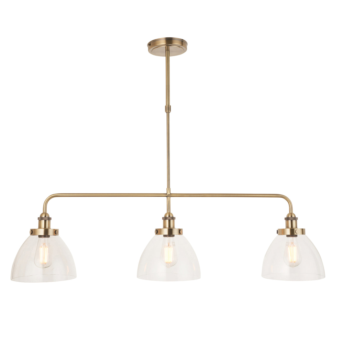 image cut out on white background of clear glass light shades housing warm white filament LEDs on a three-drop linear industrial antique brass bar light