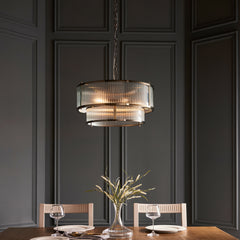 image of ribbed glass tiered pendant light with five bulbs, over a dining table