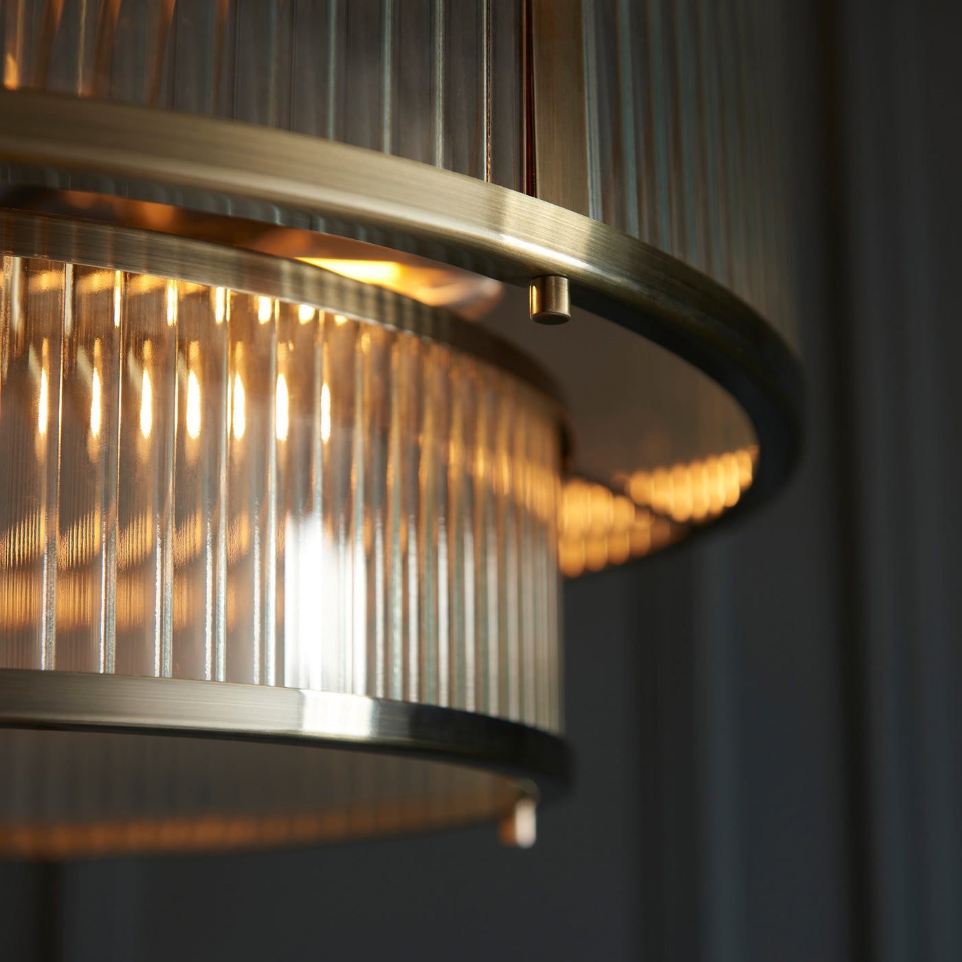 close up image of antique brass metalwork of ribbed glass pendant light
