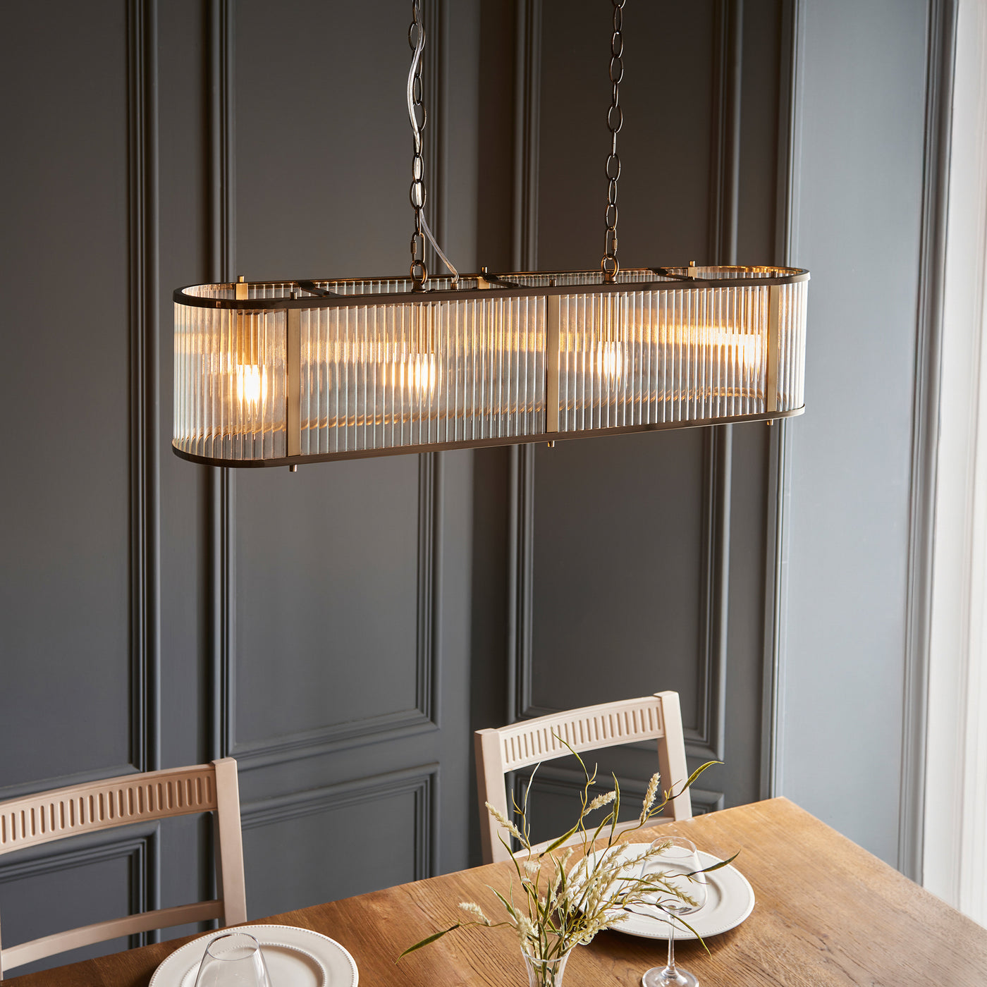 angled image of four pendant light hanging over table