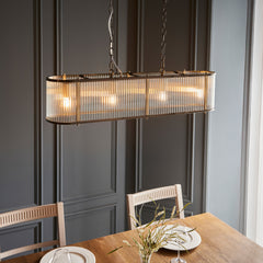 angled image of four pendant light hanging over table