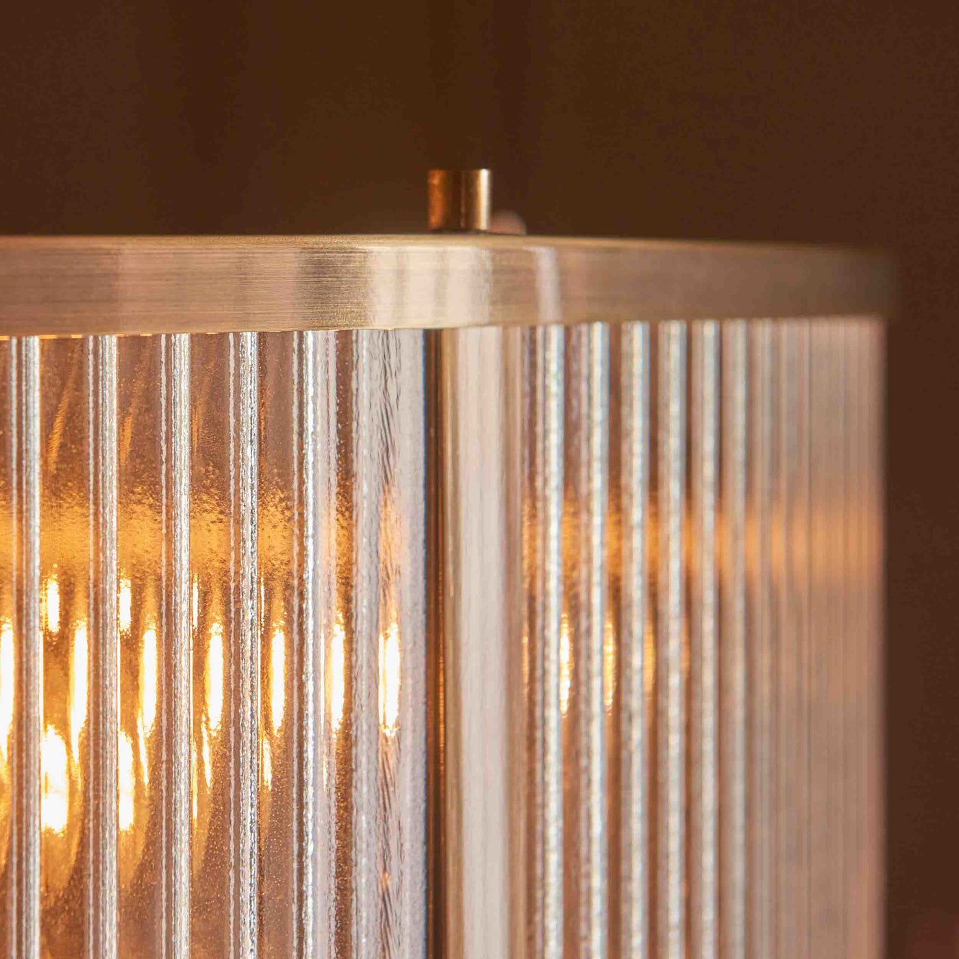 close up image of ribbed glass of pendant light with antique brass metalwork