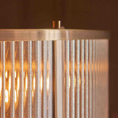 close up image of ribbed glass of pendant light with antique brass metalwork