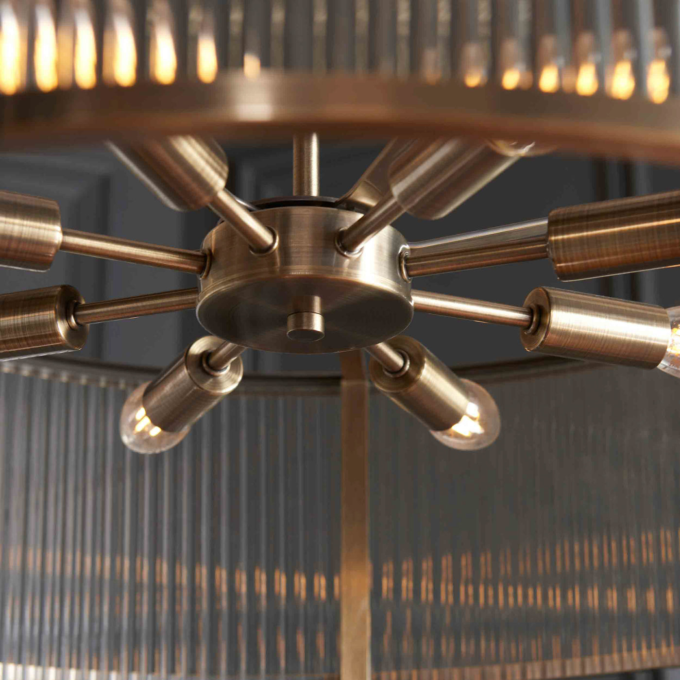 close up image taken from underneath looking up at 8 bulbs in ribbed glass pendant light