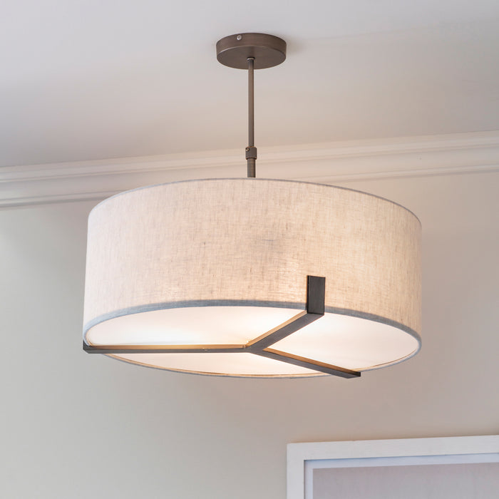 image of linen fabric light shade supported by three-pronged bronze metal framework