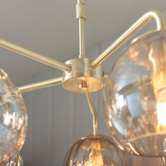 close up on satin gold fixture of dimpled glass ceiling light