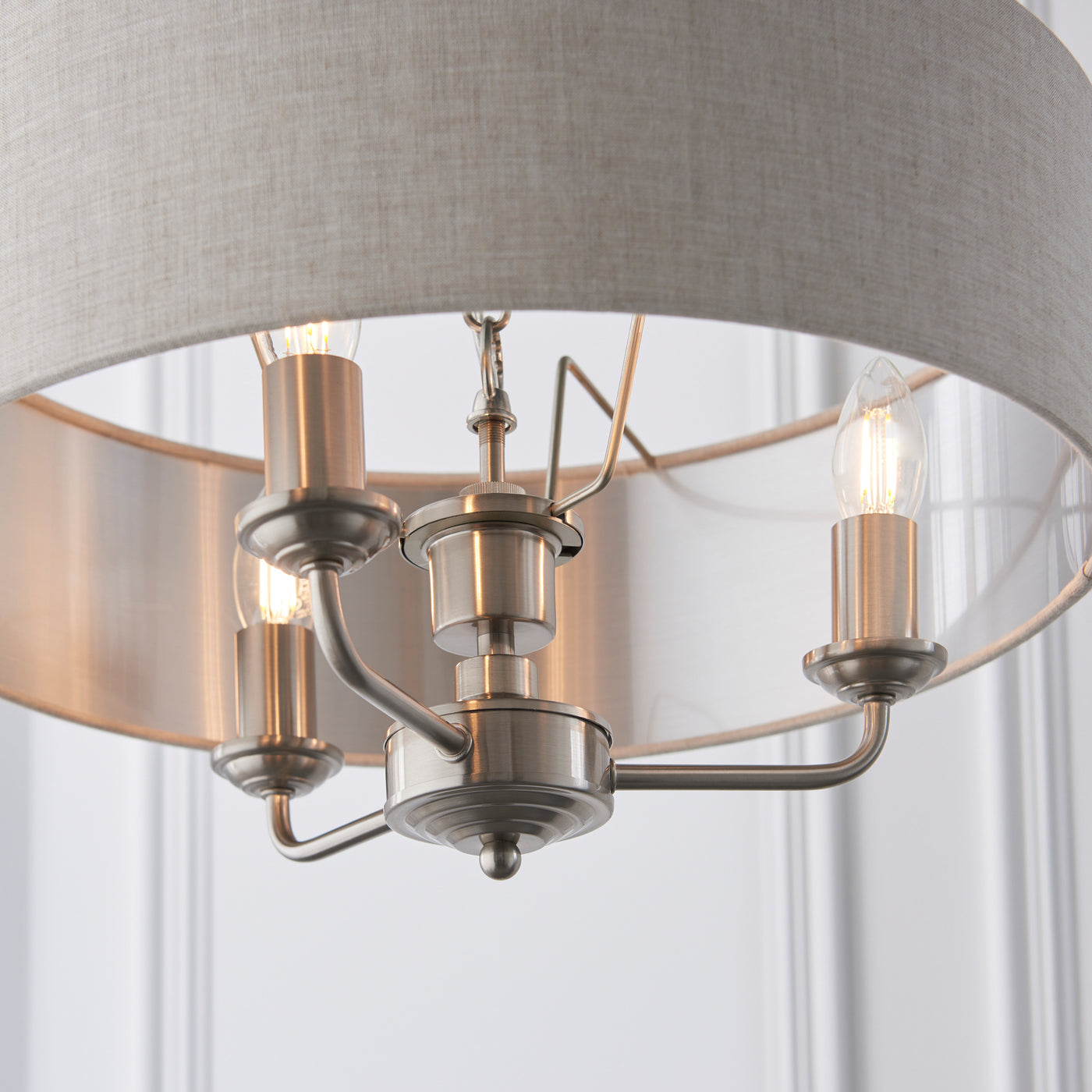 image taken upwards from under lamp to show chrome arms with candle bulbs
