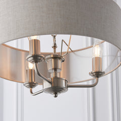 image taken upwards from under lamp to show chrome arms with candle bulbs