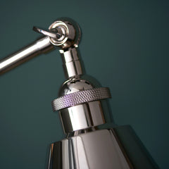 close up on top of conical nickel shade of table lamp