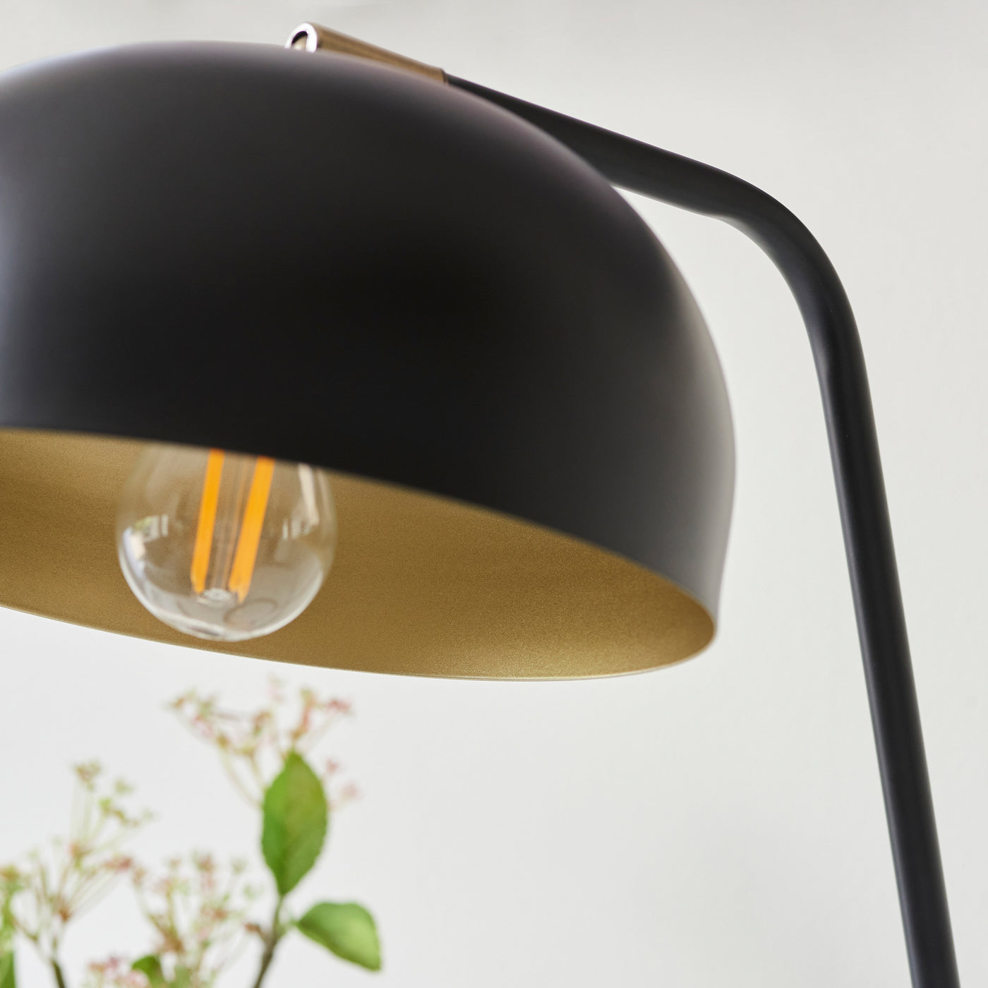 close up image of antique brass interior of matt black table lamp