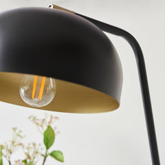 close up image of antique brass interior of matt black table lamp