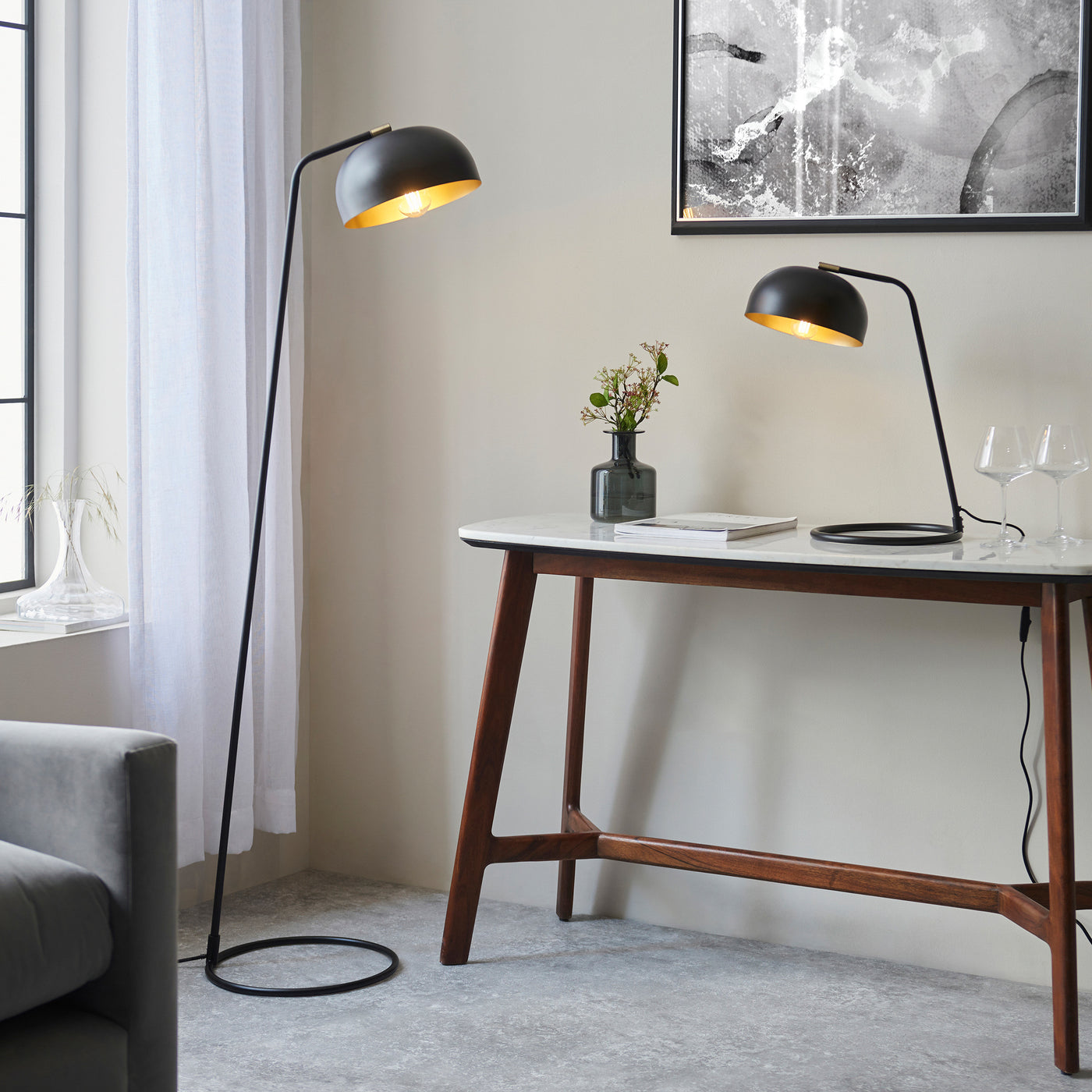image of matt black table lamp on modern console table with matching floor  lamp stood beside it