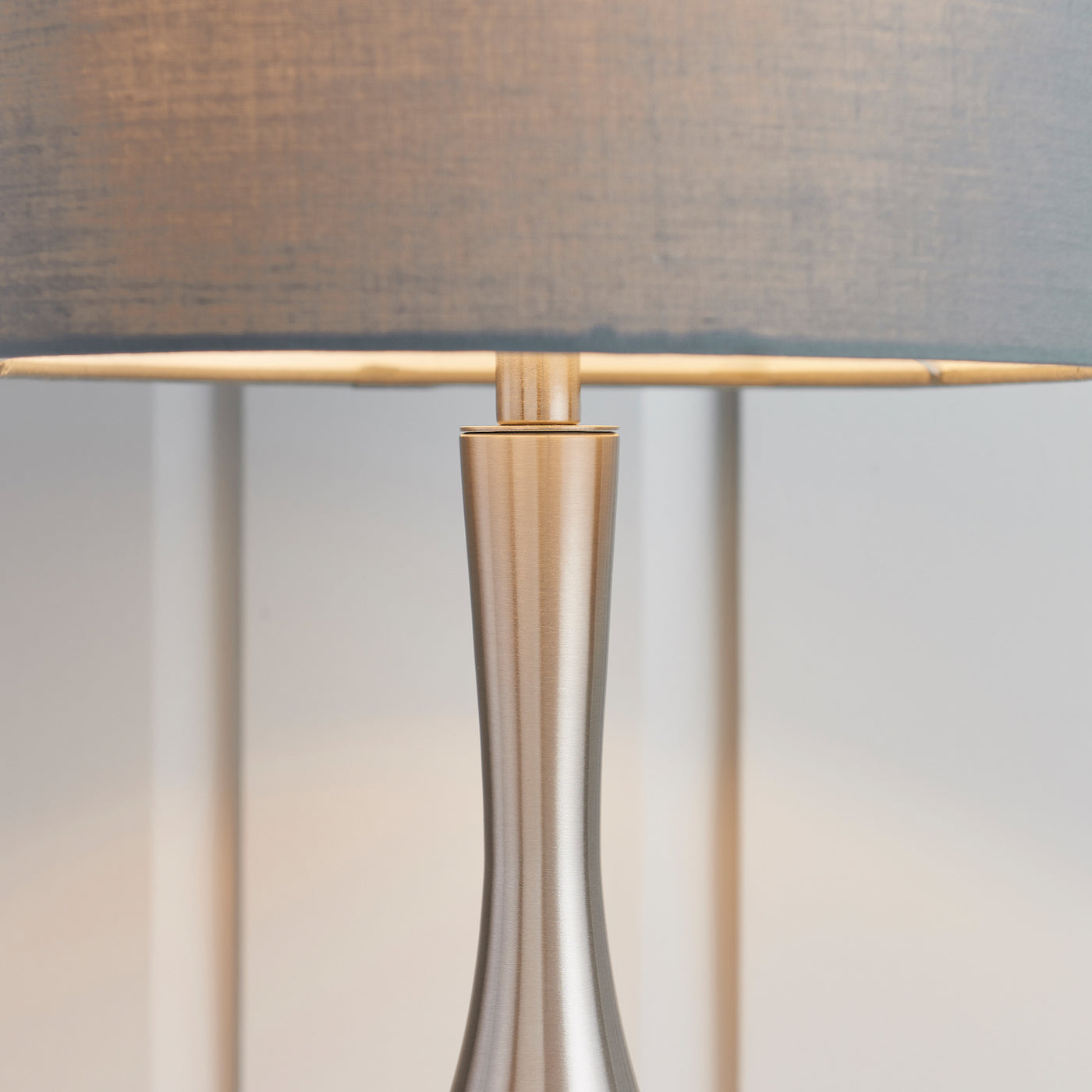 image of middle of grey lamp where shade meets slim silver body