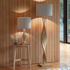 image of two twisted wooden lamps, one table and one floor, next to each other in an entryway