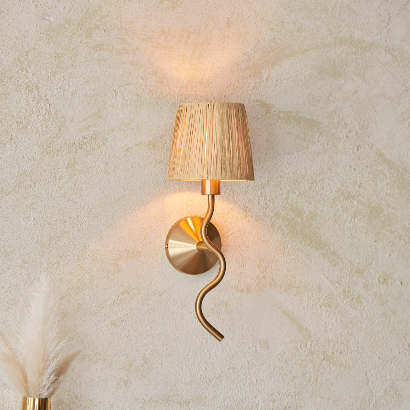 image of wriggle wall light on cream wall, emitting warm glow