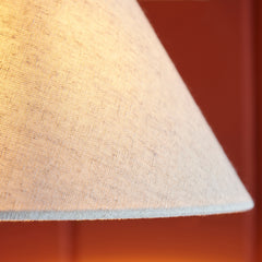 close up on fabric shade of conical wall light
