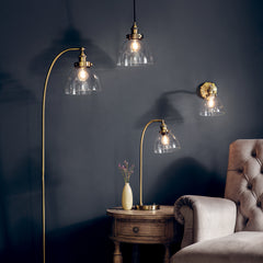 group image of all Harrington lighting range with clear glass shades and antique brass fixtures, including floor, wall, table and pendant