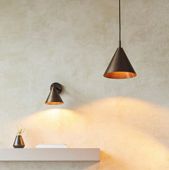 close up of antique bronze ceiling light hanging next to matching wall light